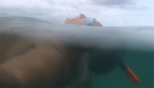 Namkhai Norbu Rinpoche, floating in the sea, from Jennifer Fox’s <em>My Reincarnation.</em>
