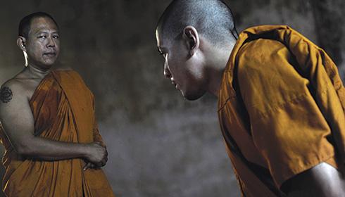 [younger Thai monk bows to senior monk]