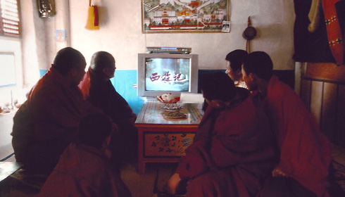 Monks and novices watch Chinese television in The Silent Holy Stones.
